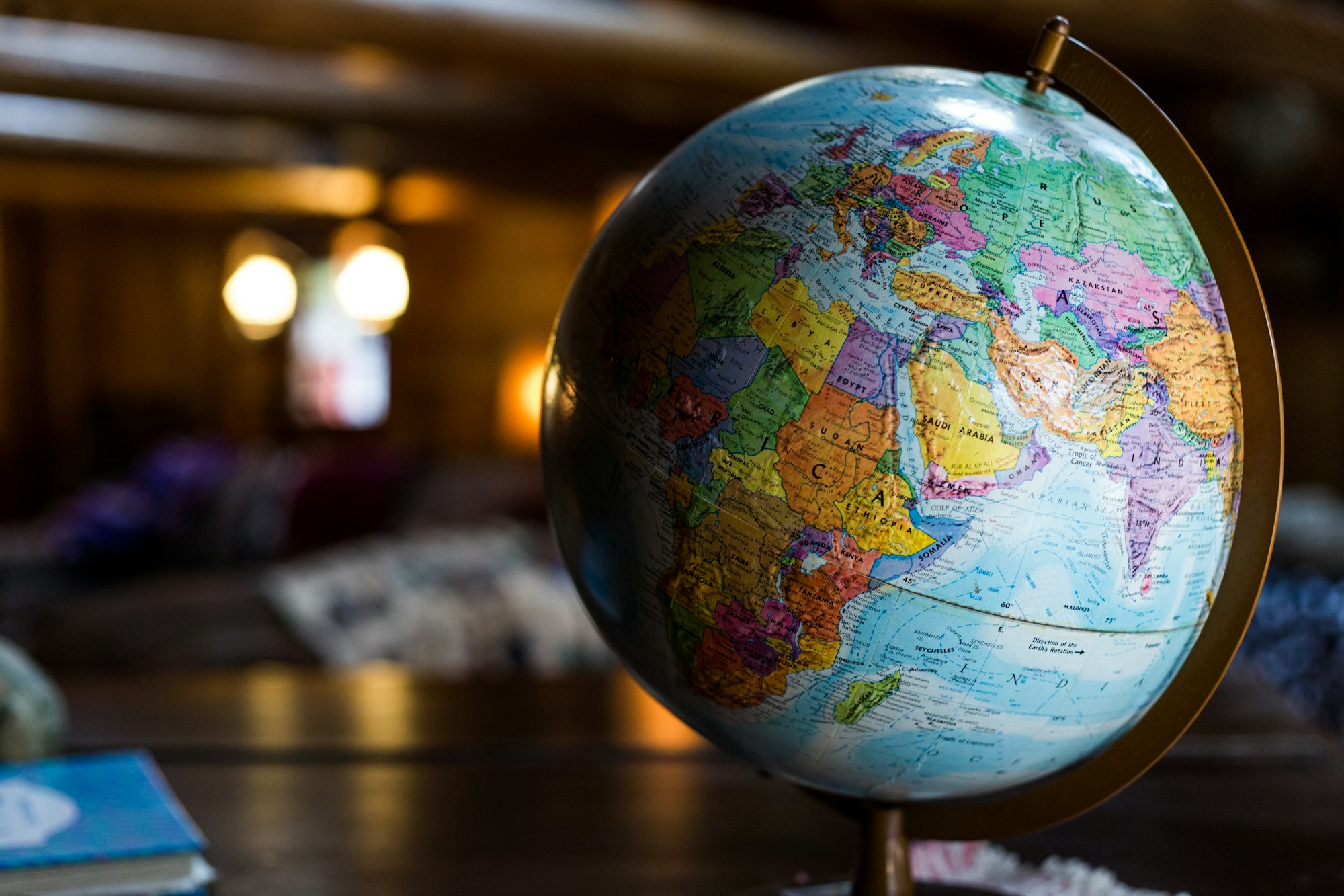 A well-travelled globe on a desk
